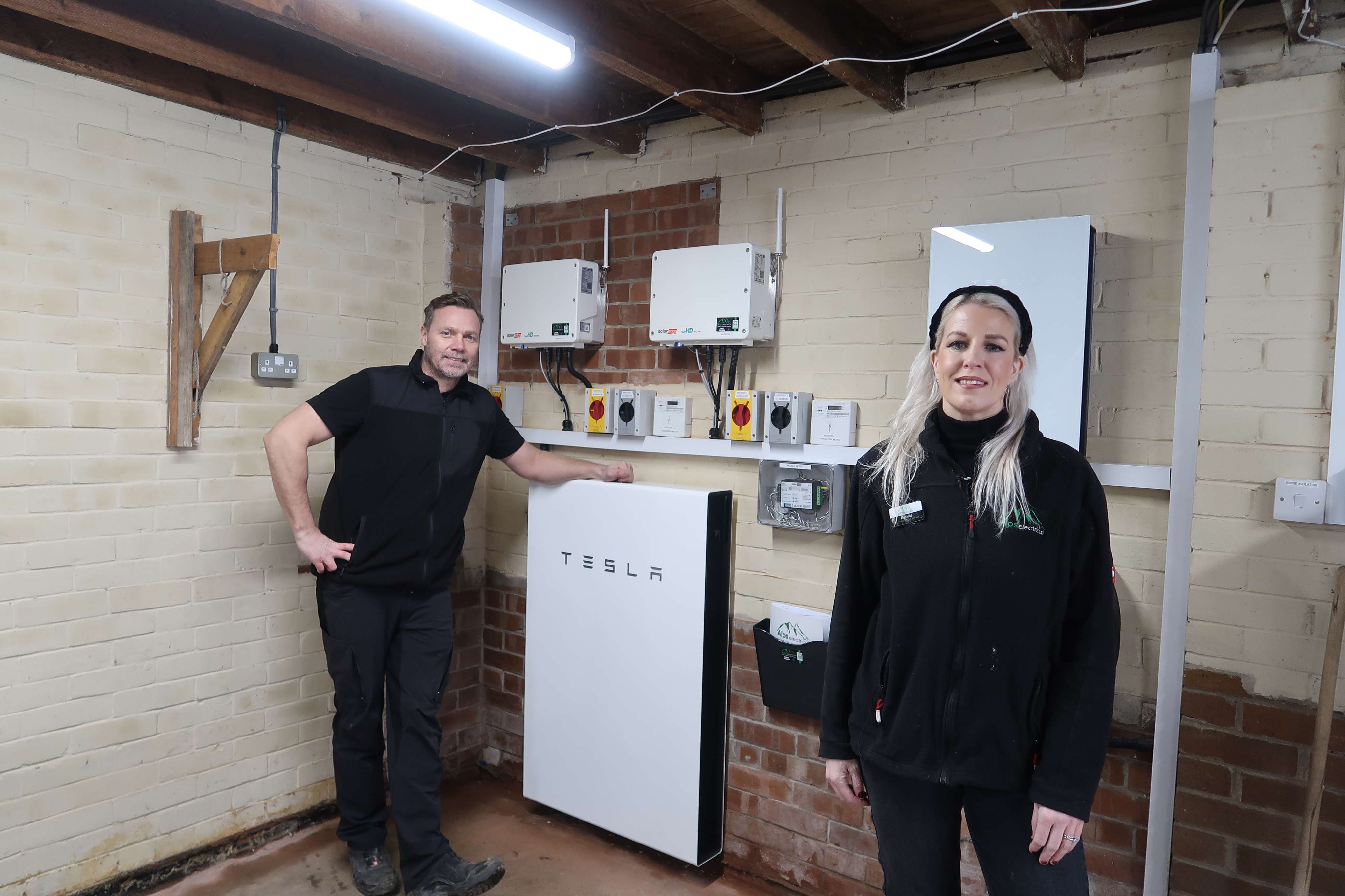 Andy and Isabella Pemberton with Tesla Powerwall and SolarEdge inverter installation